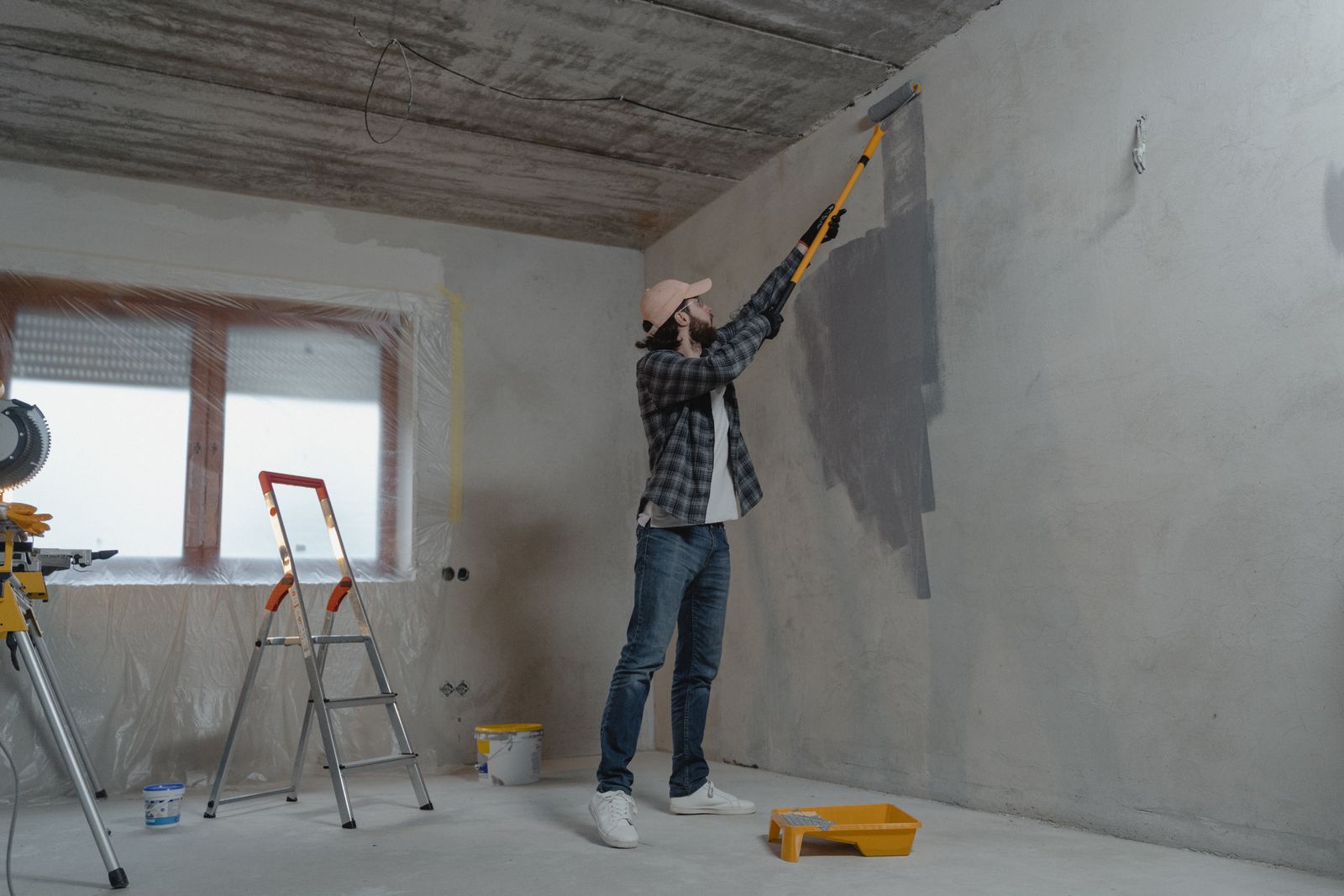 A painter rolling a smooth, even coat of paint onto an interior wall